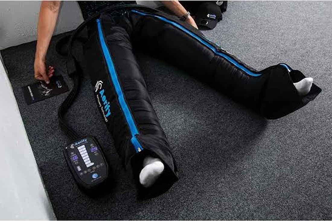 Pressotherapy boots in use, with the control unit beside them